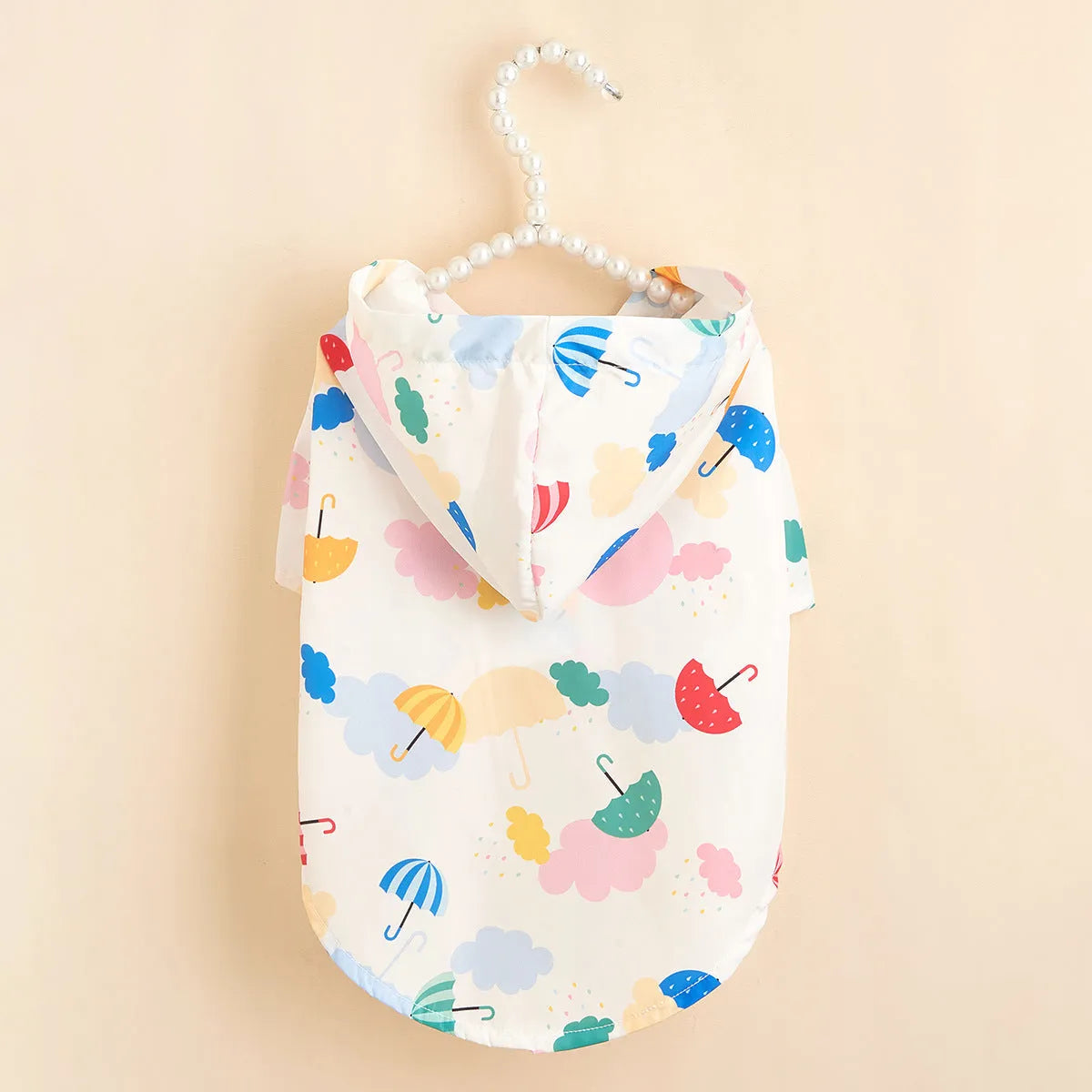 Colourful cartoon umbrella pattern polyester dog raincoat laid flat showing full design