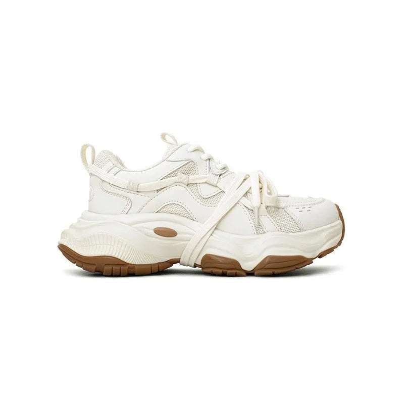 Beige women's casual sneakers with a platform heel and round toe, showing lace-up front.