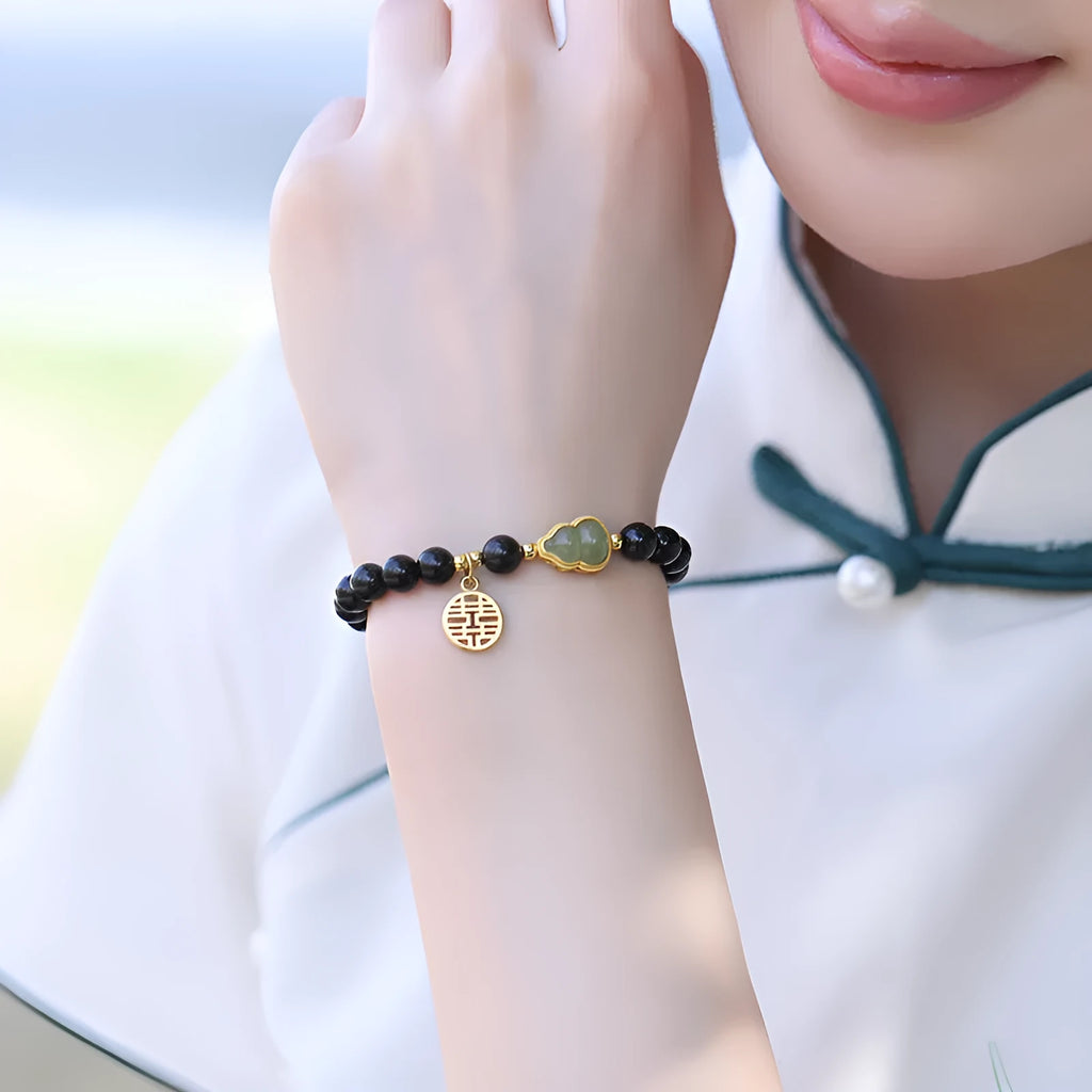 Natural black obsidian bracelet with Hetian jade gourd pendant in geometric bead design