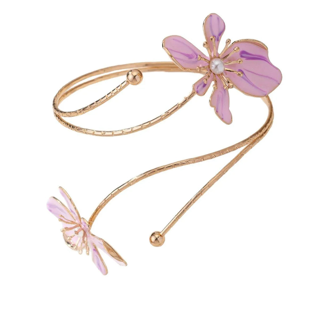 Close-up of a pink alloy armband with a hollow patterned design.