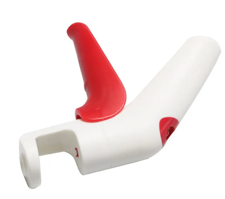 Cherry pitter kitchen tool with soft-grip handle and stainless steel plunger on a plastic base.