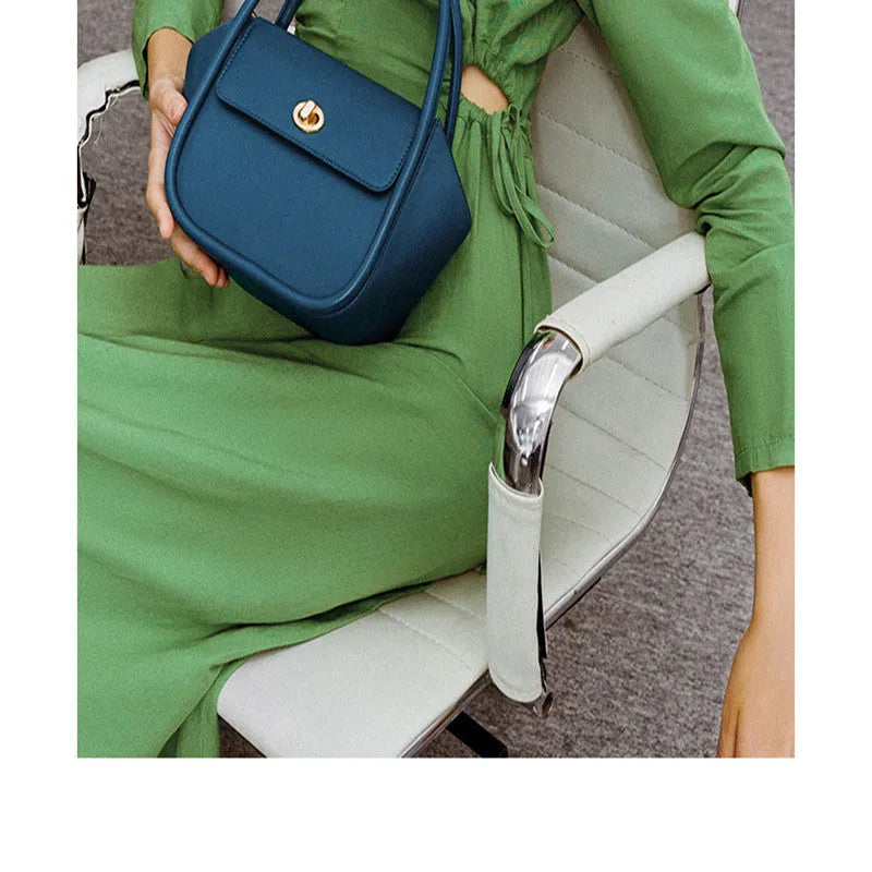 A wing-shaped cow leather women's tote bag with a cross-body strap and latch closure in a choice of colours.