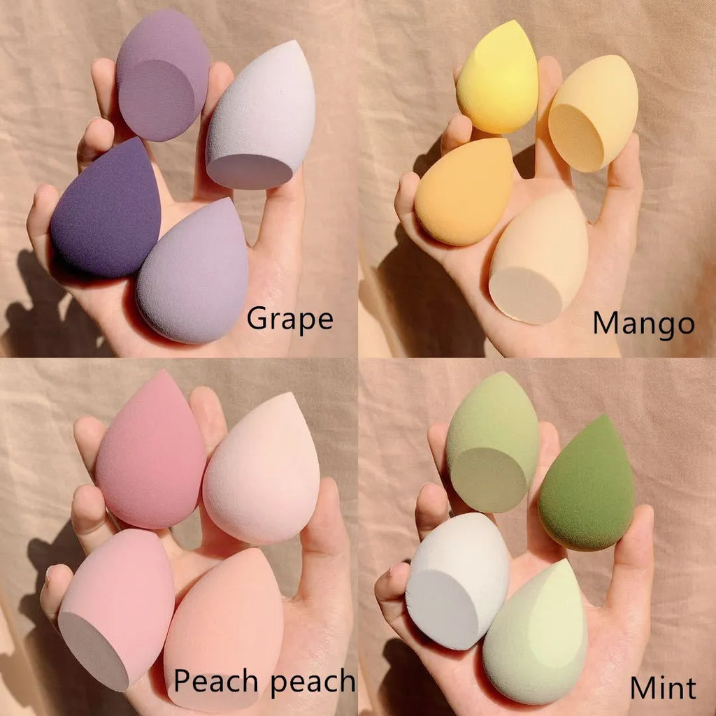 Four colourful makeup sponge eggs in Grape, Mango, Mint and Peach on white background