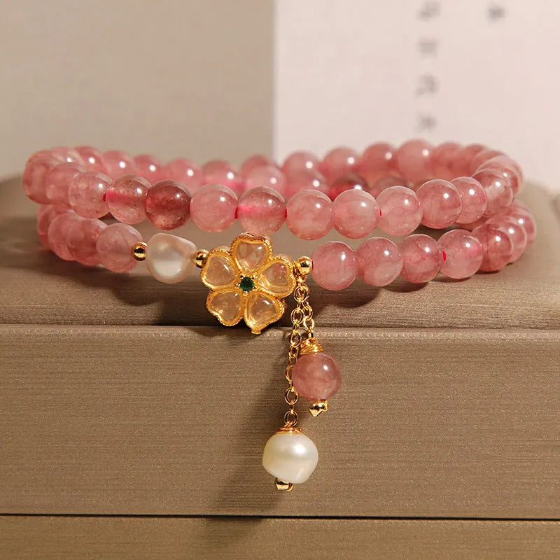 Women's double ring bracelet with strawberry quartz four-leaf clover charm and alloy inlay detailing
