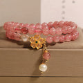Women's double ring bracelet with strawberry quartz four-leaf clover charm and alloy inlay detailing