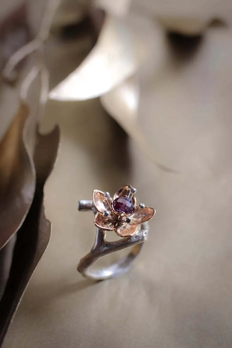 Silver two-tone floral geometric alloy women's ring shown on a white background.