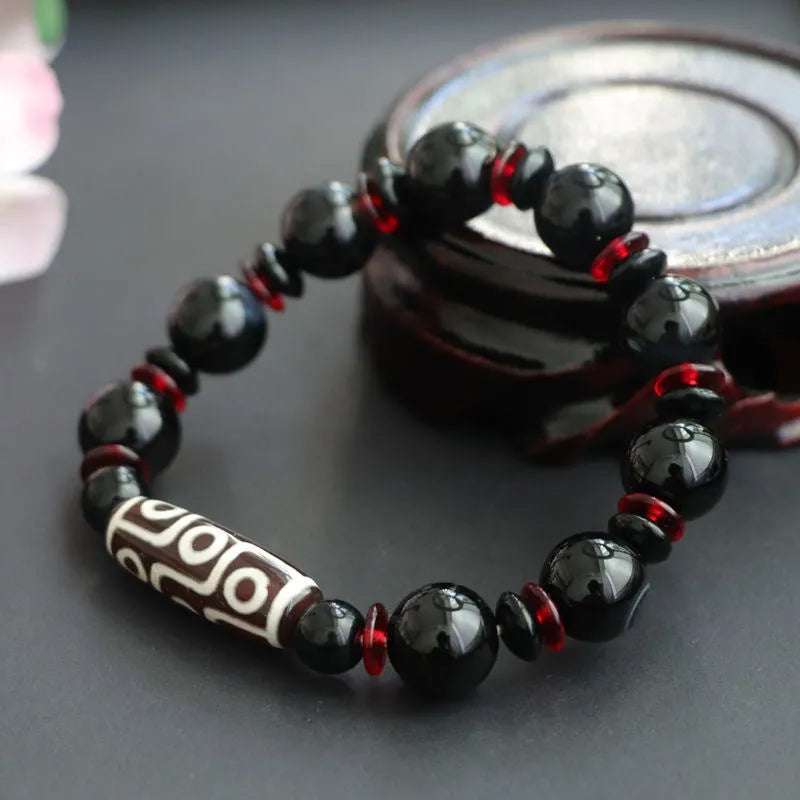 Black agate dzi bead bracelet with 11mm geometric beads in hand-woven construction
