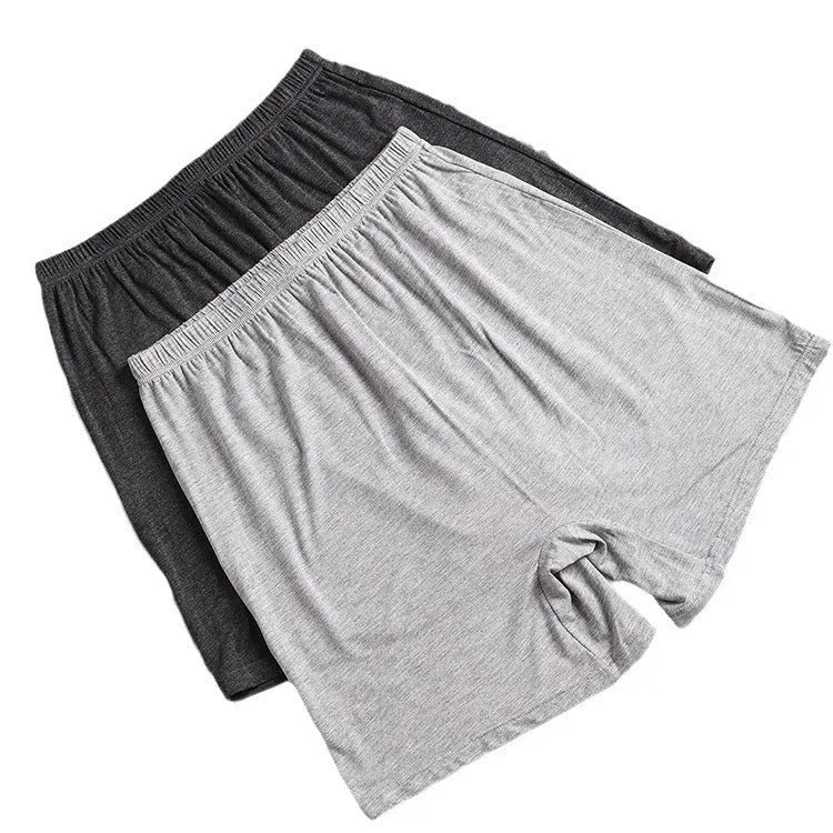 Man wearing solid colour high waist modal boxer shorts in a neutral shade.
