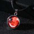 Close-up of a constellation design glass pendant on an alloy chain necklace with extension.
