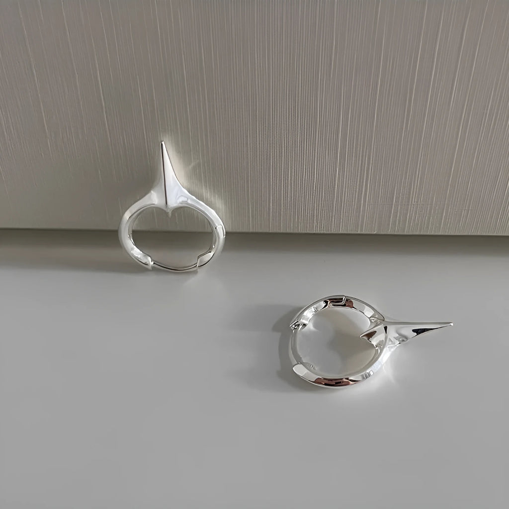 Geometric star-shaped ear clip earrings in platinum colour with copper construction