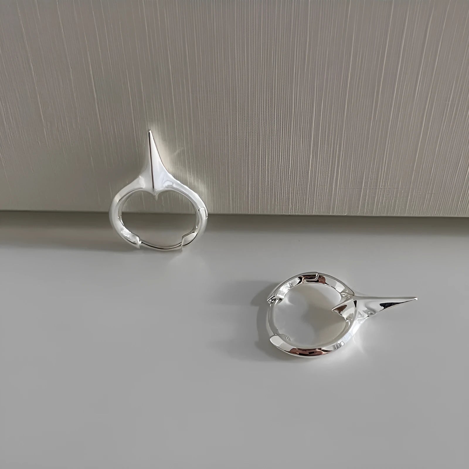 Geometric star-shaped ear clip earrings in platinum colour with copper construction