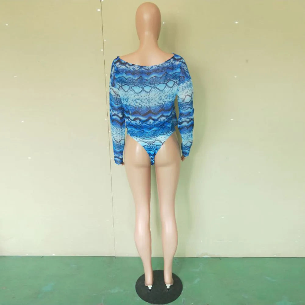 Women's blue floral print long sleeve swim top with matching snakeskin print bikini shorts.