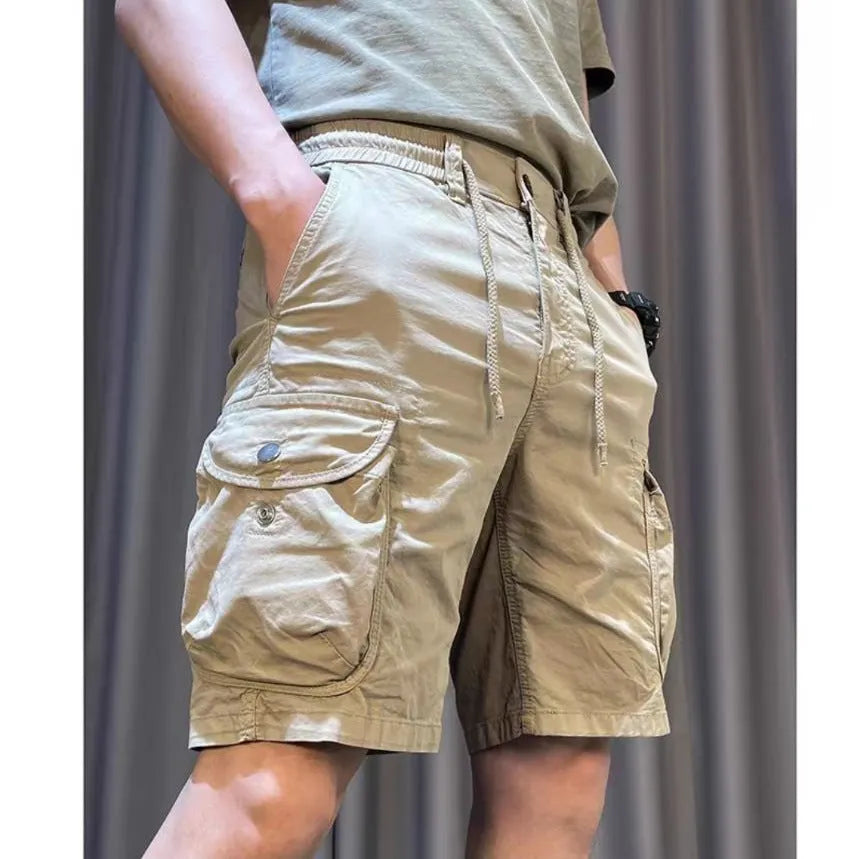 Loose straight-leg Korean-style overalls pants in khaki with multiple pockets and an elasticated waist.