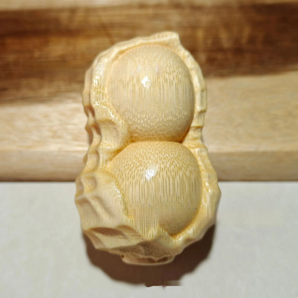 Modern simplicity style solid bamboo carving peanut ornament on a neutral background.