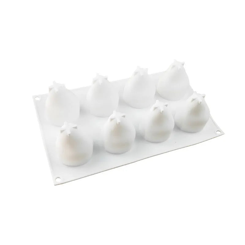 A green silicone baking mould with six cavities shaped like pineapples and pine cones.