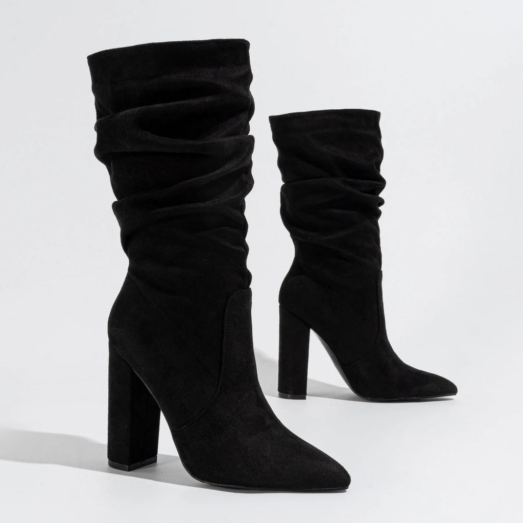 Black suede women's boots with a chunky high heel and pointed toe, shown on a mid-calf length.