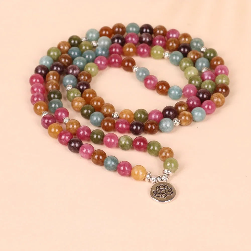 Close-up of a 108-bead alloy bracelet with a multi-layer lotus string design in a tourmaline colour.