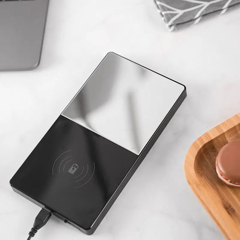 2-in-1 heating mug cup warmer with wireless charger on a desk with a glass mug