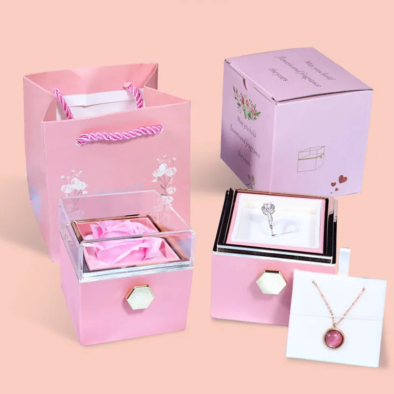Rotating rose jewellery gift box with preserved real flower under acrylic cover and rotating drawer