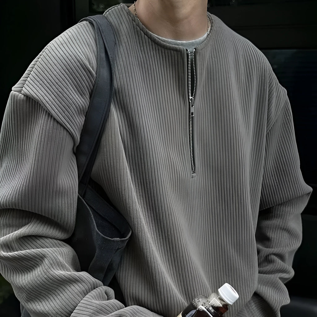A grey loose-fitting long sleeve women's pullover top hanging flat.