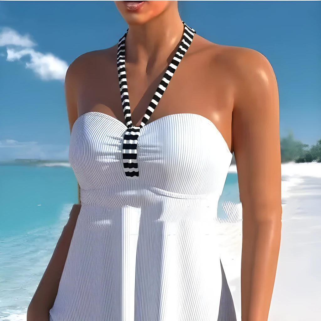 Women's off-shoulder swimsuit with black and white stripes on solid colour background