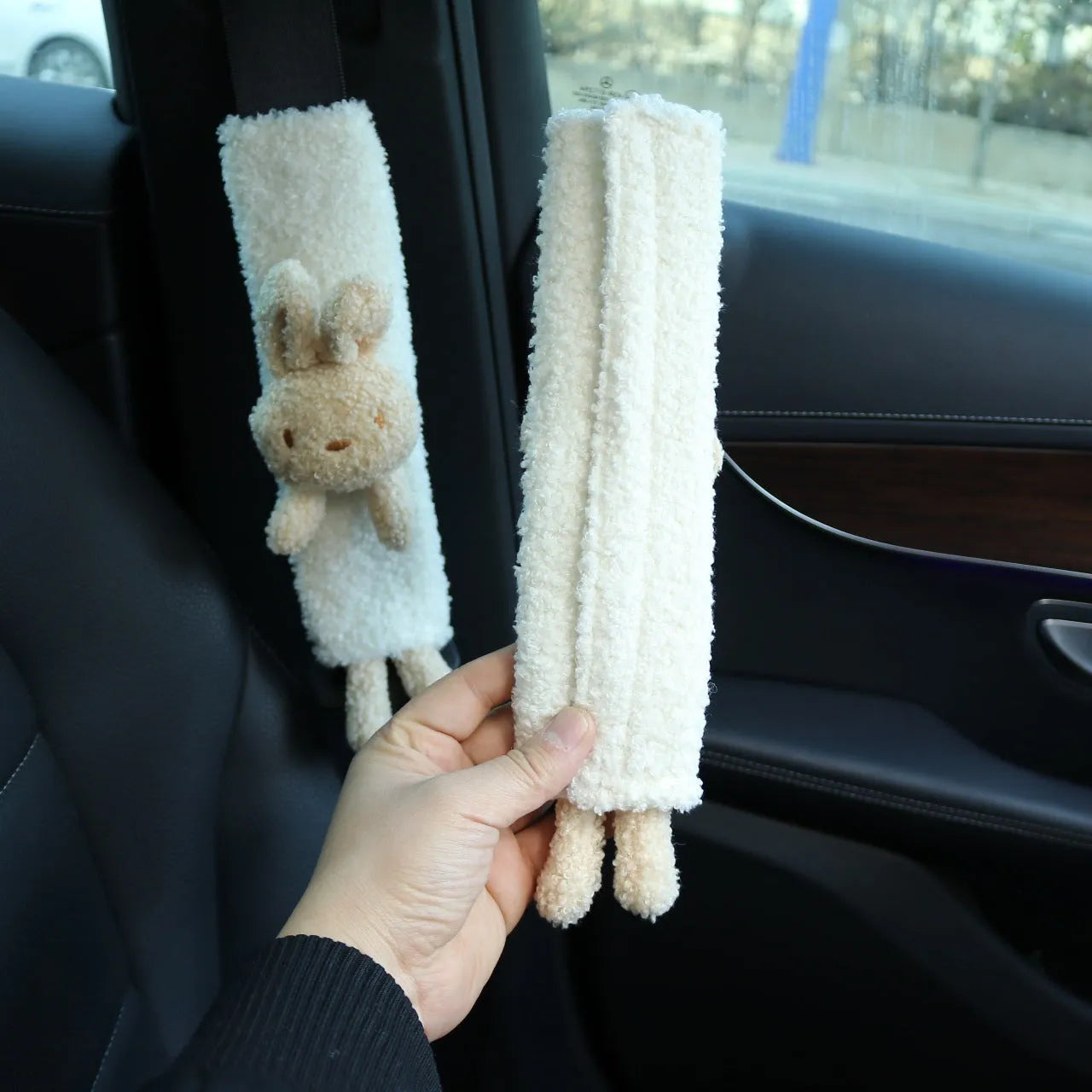 Plush lamb wool car seatbelt shoulder protector with cartoon rabbit and bear designs.
