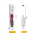 Black and white electric hand-held milk frother for coffee preparation on kitchen counter