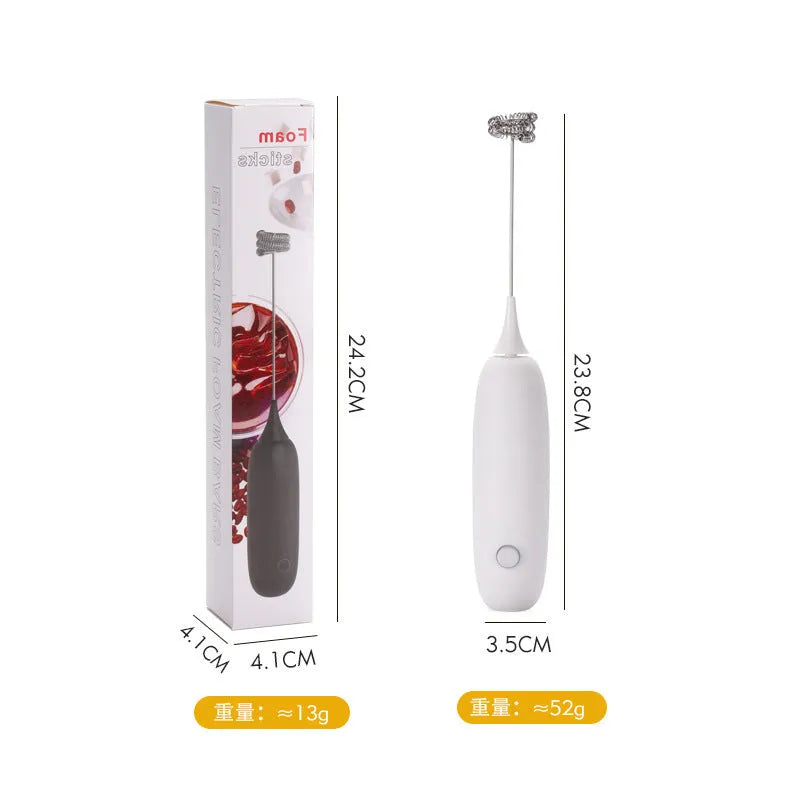 Black and white electric hand-held milk frother for coffee preparation on kitchen counter