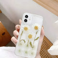 White epoxy daisy floral design on a clear TPU protective phone case for iPhone.