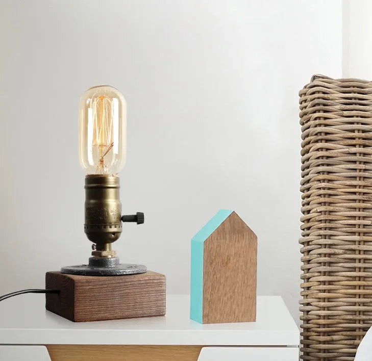 Small wooden and iron water pipe table lamp on a table