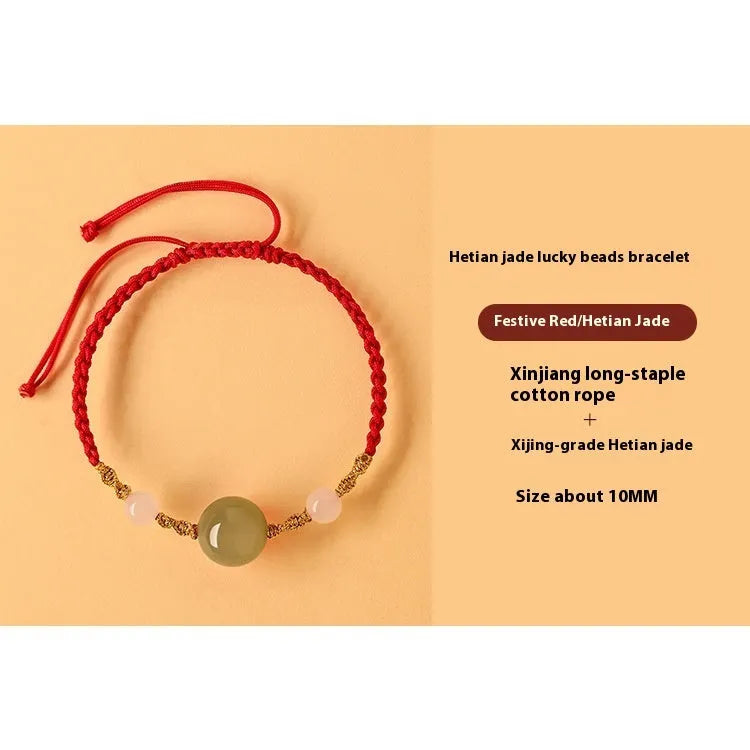Hand-woven red rope bracelet with Hetian jade lucky charm beads on a model's wrist.