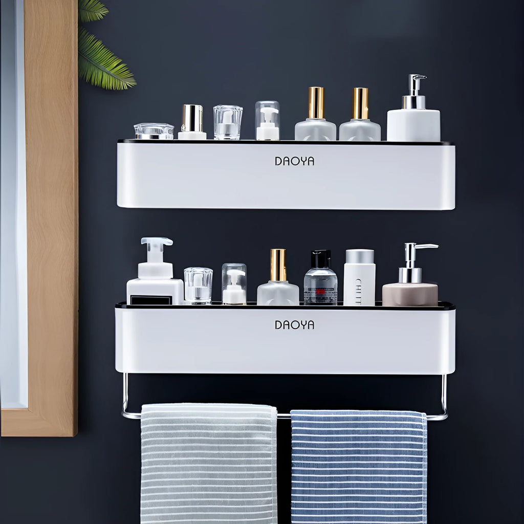 Black adhesive plastic bathroom shelf mounted on a wall holding shampoo and shower gel bottles.