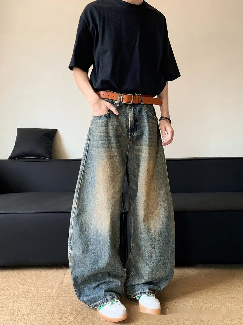 Man wearing retro blue distressed wide-leg denim jeans with machete detailing