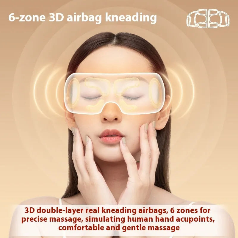 White rechargeable eye massager with hot compress and airbag massage functions on a table.