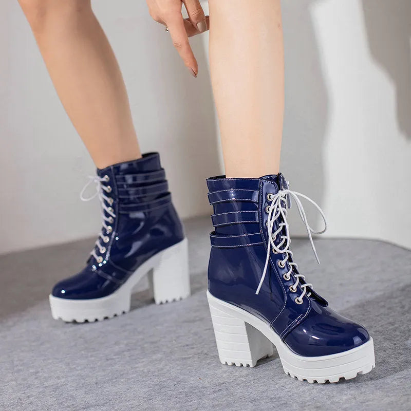 Women's black thick heel ankle boots with round toe and front lace-up on a waterproof platform.
