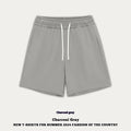 Child wearing loose fit cotton denim shorts in charcoal grey, showing casual summer style