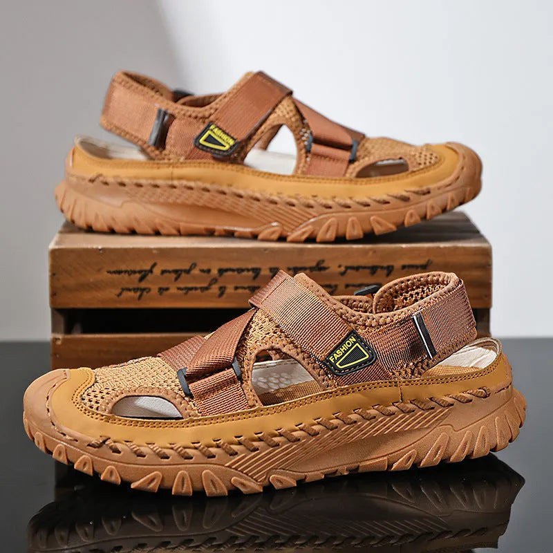Men's grey casual sandals with a mesh lining, genuine leather upper, and an elastic band toe holder on a rubber sole.