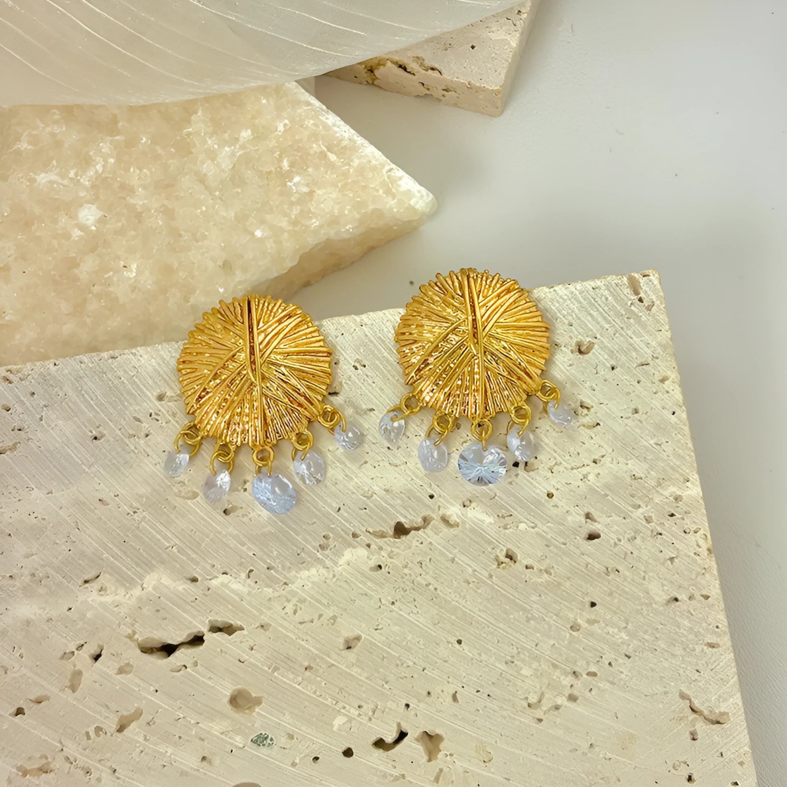 Geometric gold metal hoop earrings with round design elements