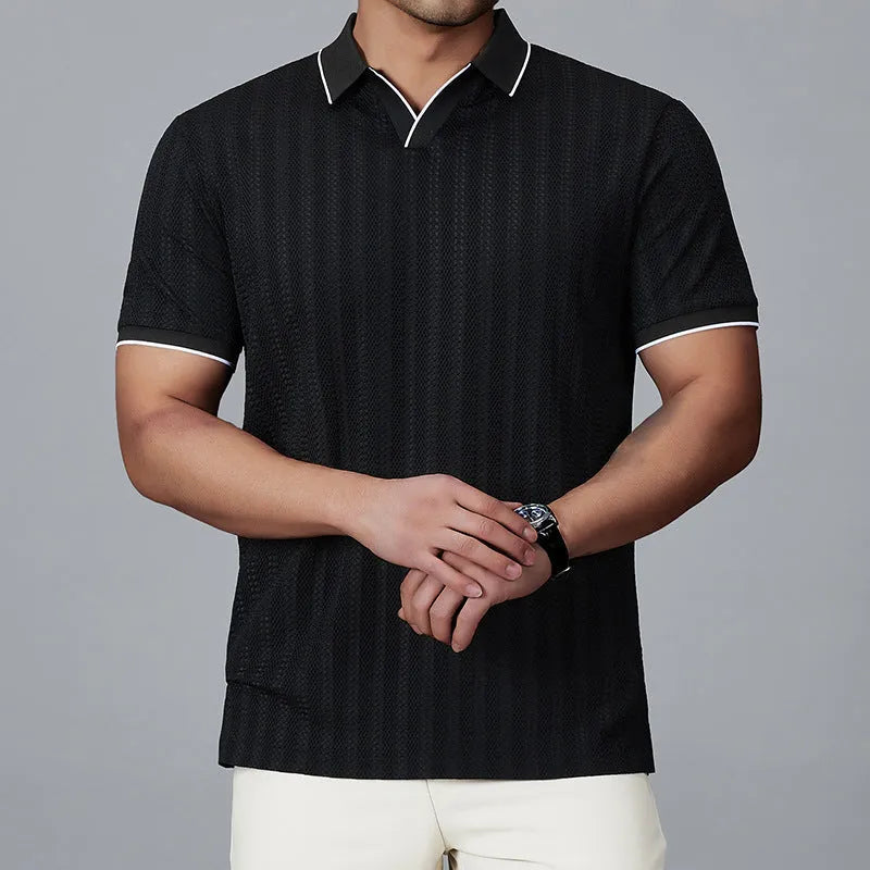 Man wearing a loose-fit black nylon polo shirt, short sleeves, casual style.