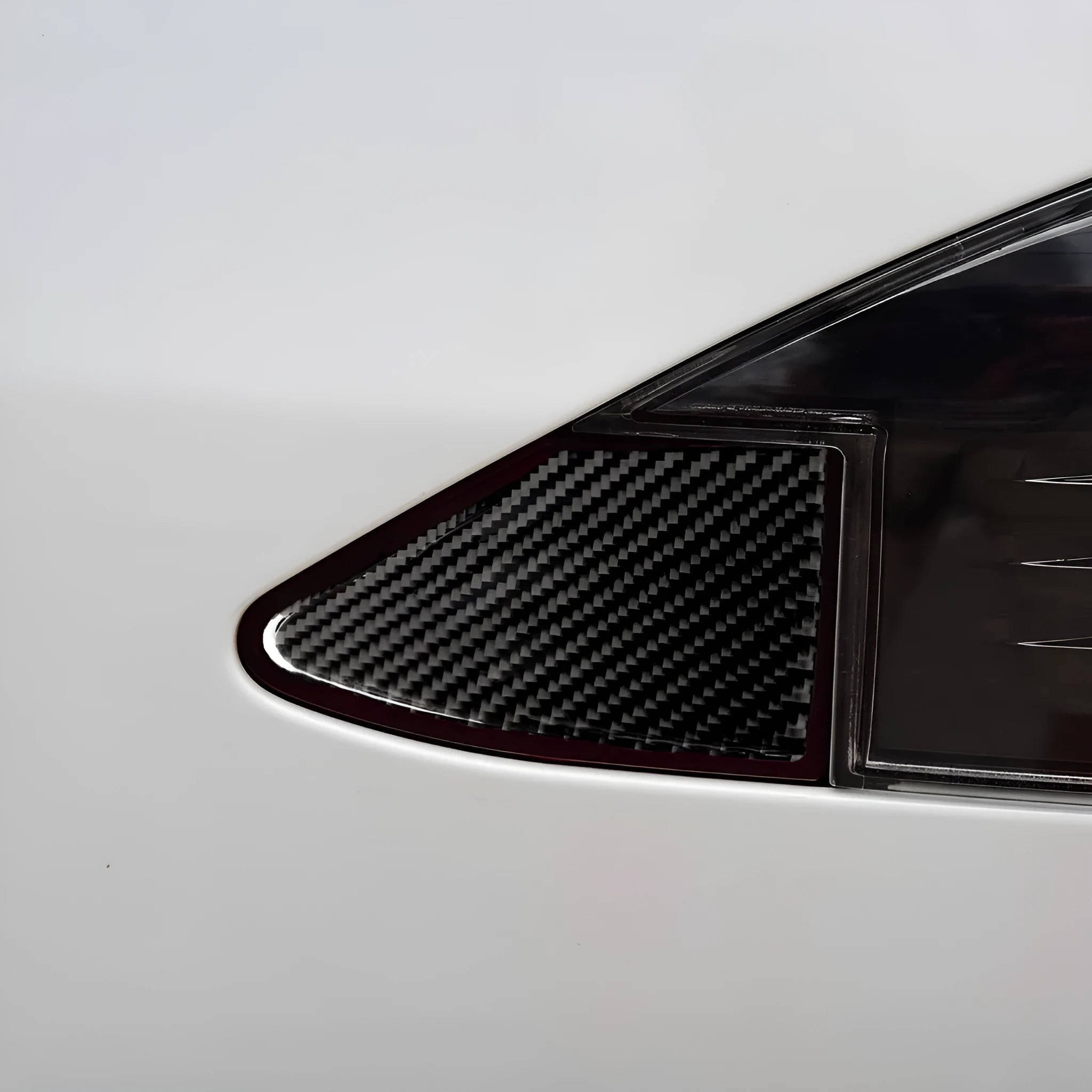Carbon fibre USB charging port decorative sticker with 3M adhesive backing.