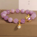 Purplish red mauve jade rabbit head charm on a clear crystal bracelet, Mori style design.