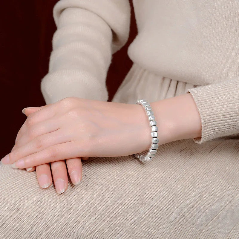 Handmade wooden women's bracelet with silver-coloured irregular square design on elastic band