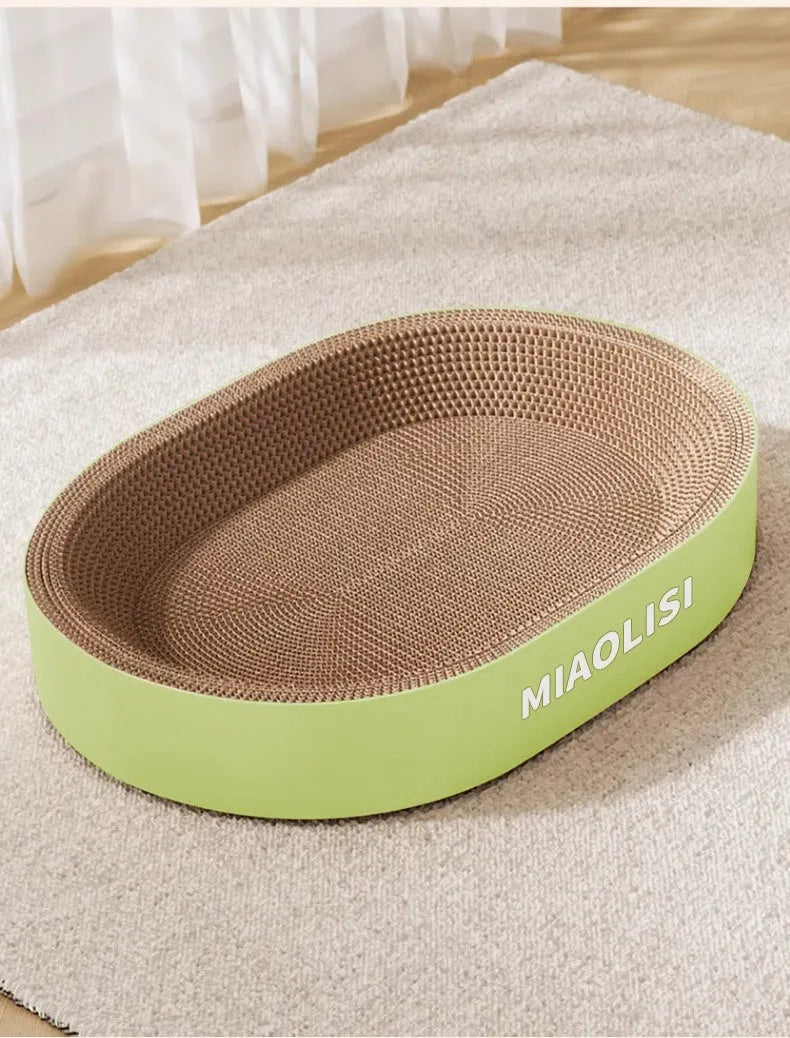 Green oval corrugated paper cat scratch board nest showing textured scratching surface and central bed area.