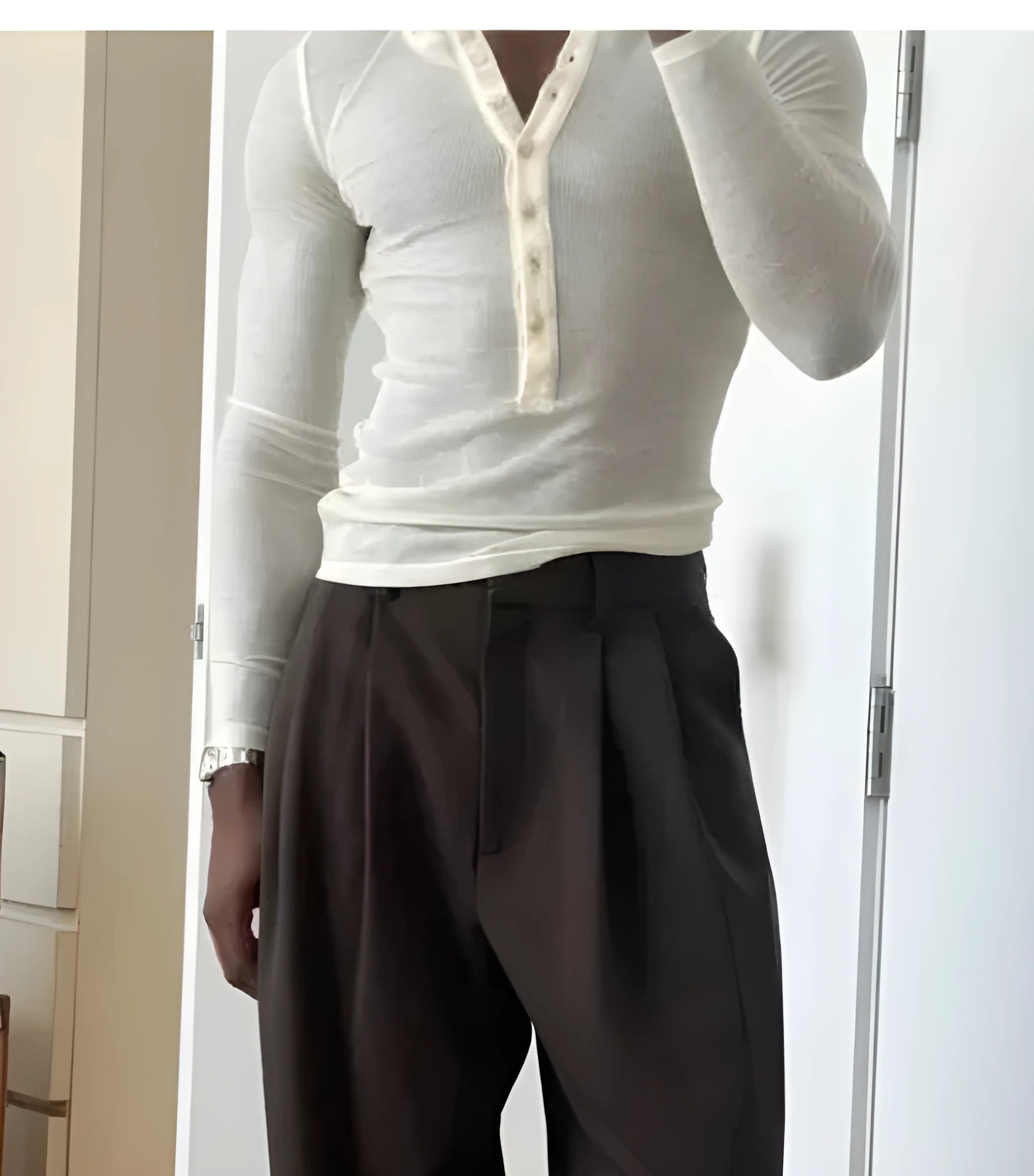 Men's cream apricot coloured ribbed long sleeve henley top with three-button front.