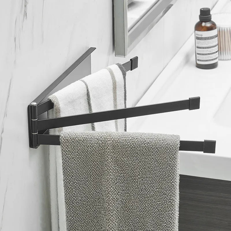 Nordic style black folding towel rack mounted on a bathroom wall