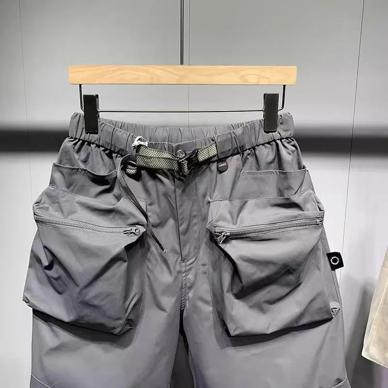 Men's large size loose fitting black shorts with pockets and straight leg hem.
