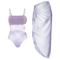 Purple one-piece swimsuit and matching wrap skirt set on a hanger.