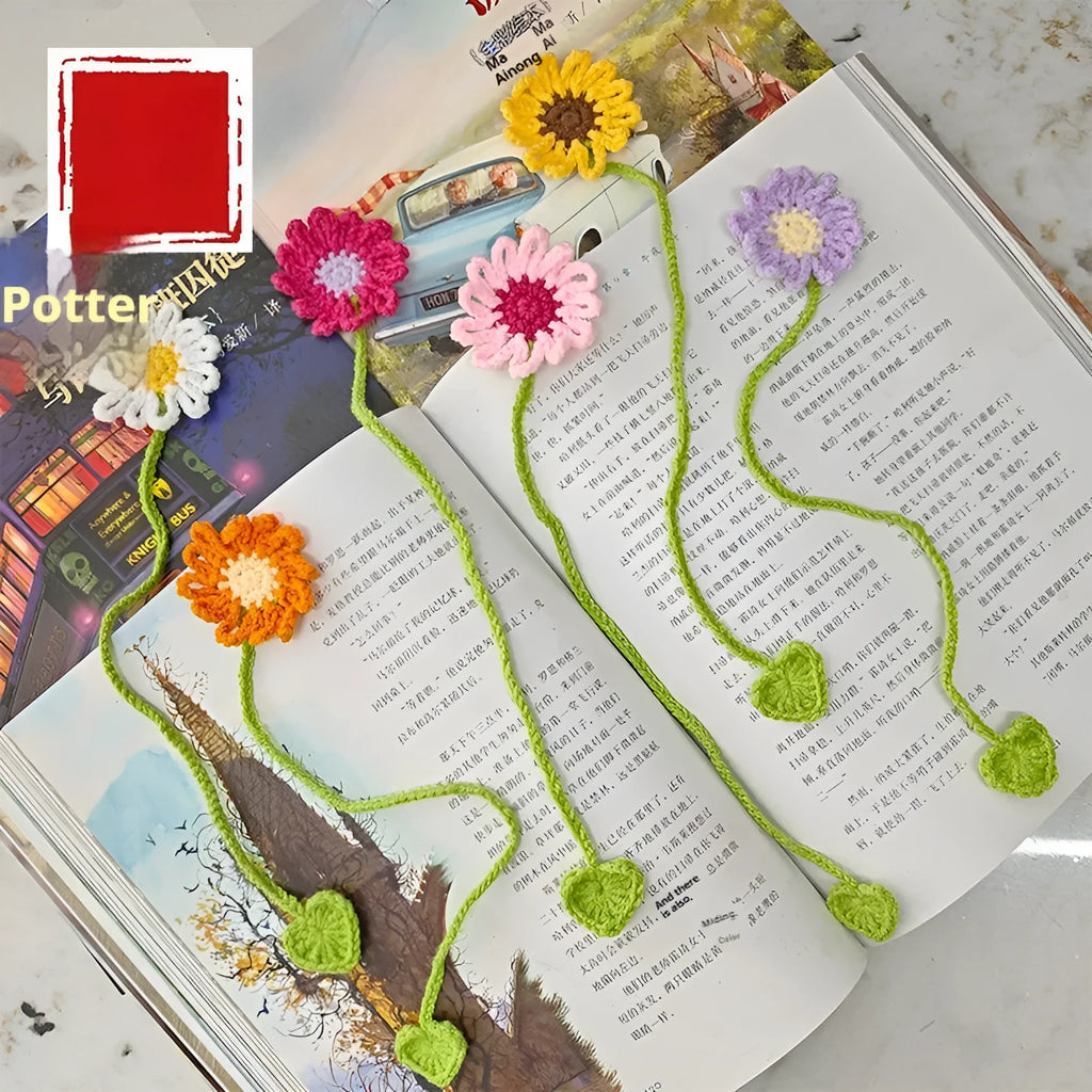 Hand-crocheted white wool bookmark with a small daisy, showing its textured four-strand milk cotton construction.