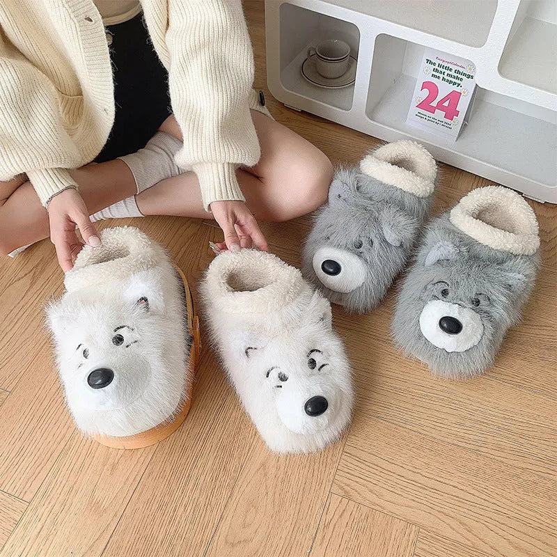 Grey ankle wrap slippers with a plush upper and a non-slip rubber sole, shown on a wooden floor.