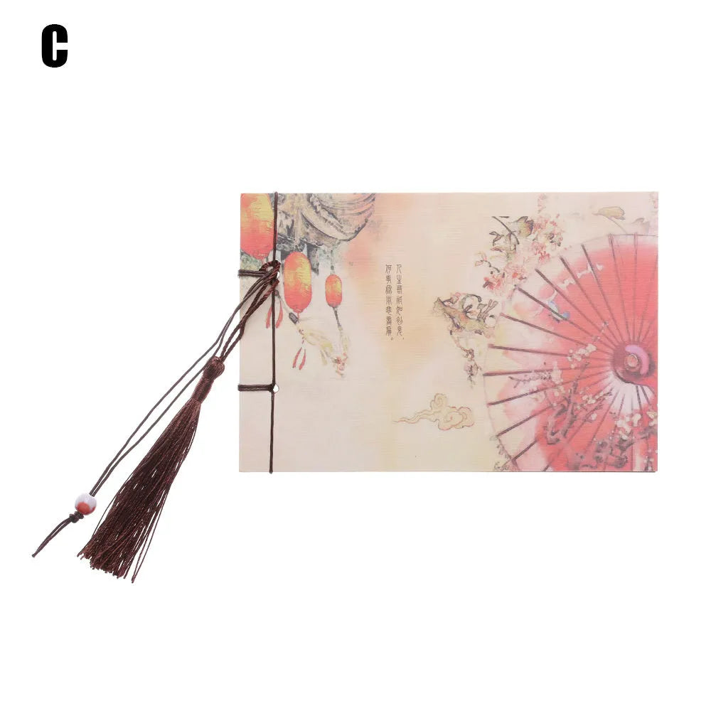 Kraft paper notebook with a tied tassel on the cover, showing hand-stitched spine.
